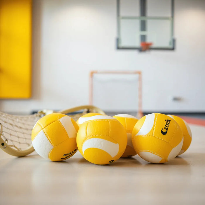 NOCSAE certified-style lacrosse balls on a training table with lacrosse sticks softly blurred in the background